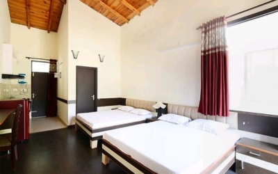 Spacious Studio Apartment interior with two beds and kitchen area